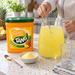 Preparing Tang Pineapple drink in a glass pitcher